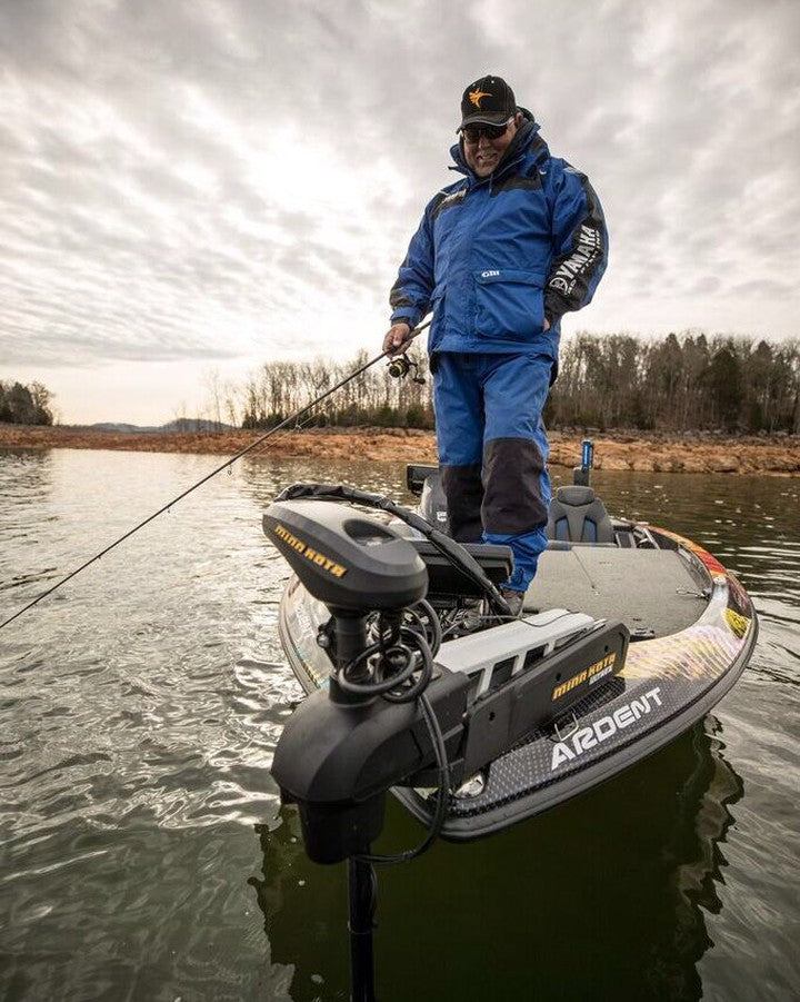 a person standing on a boat and fishing